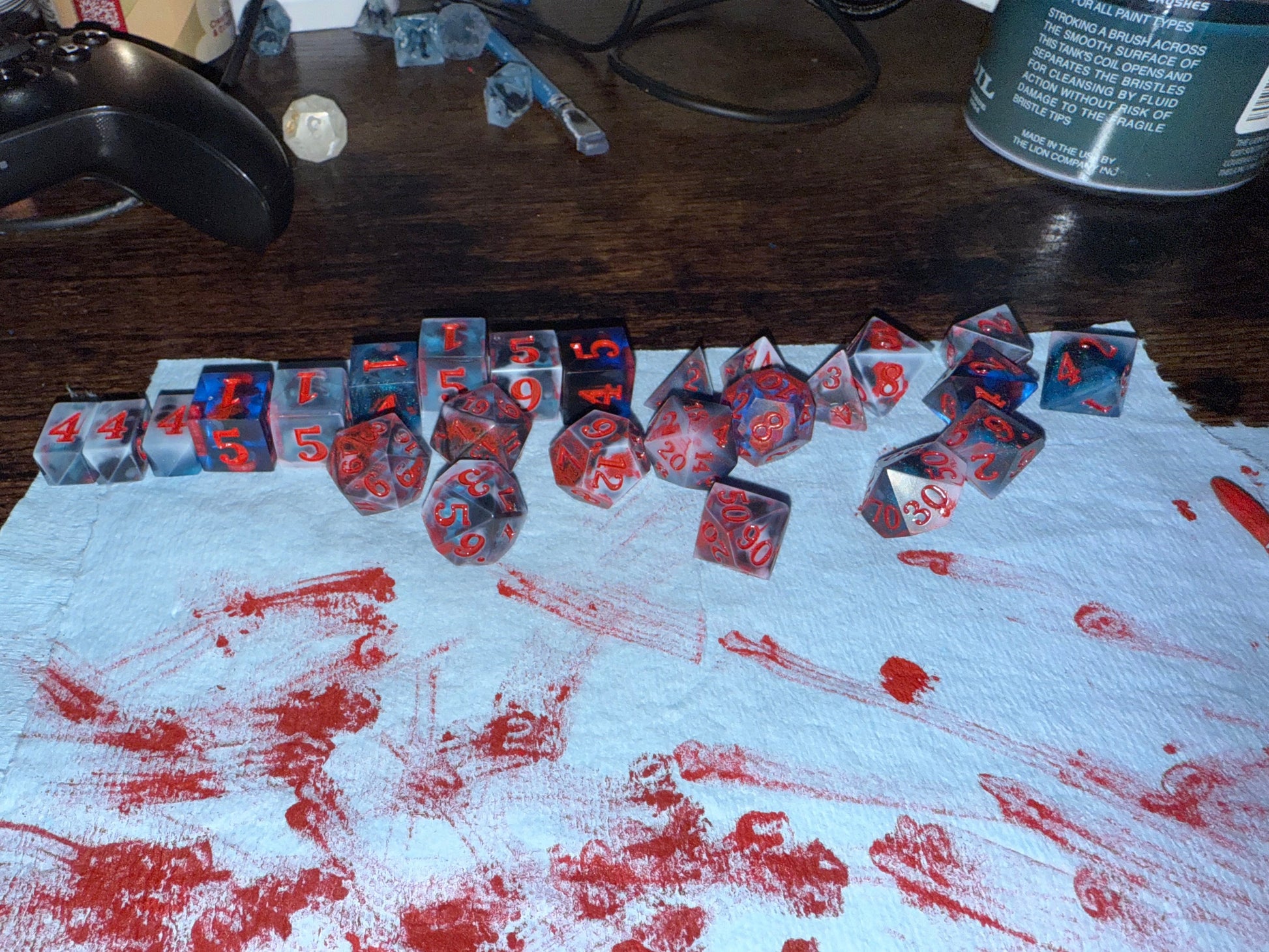 Blue resin dice set with red inked numbers